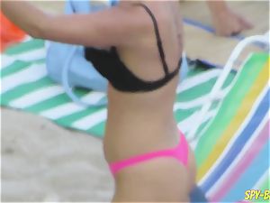 pink swimsuit amateur stripped to the waist spycam Beach chicks