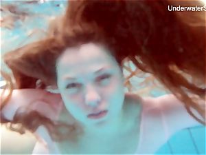 sandy-haired Simonna flashing her figure underwater